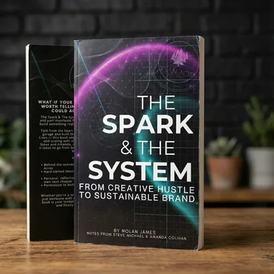 The Spark and The System, the book, on a table