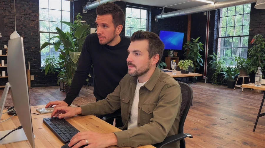 Steve and Nolan building a page together at a desktop screen