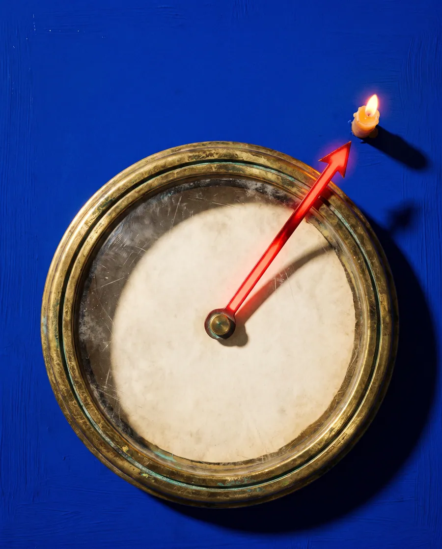A brass compass on a bright field