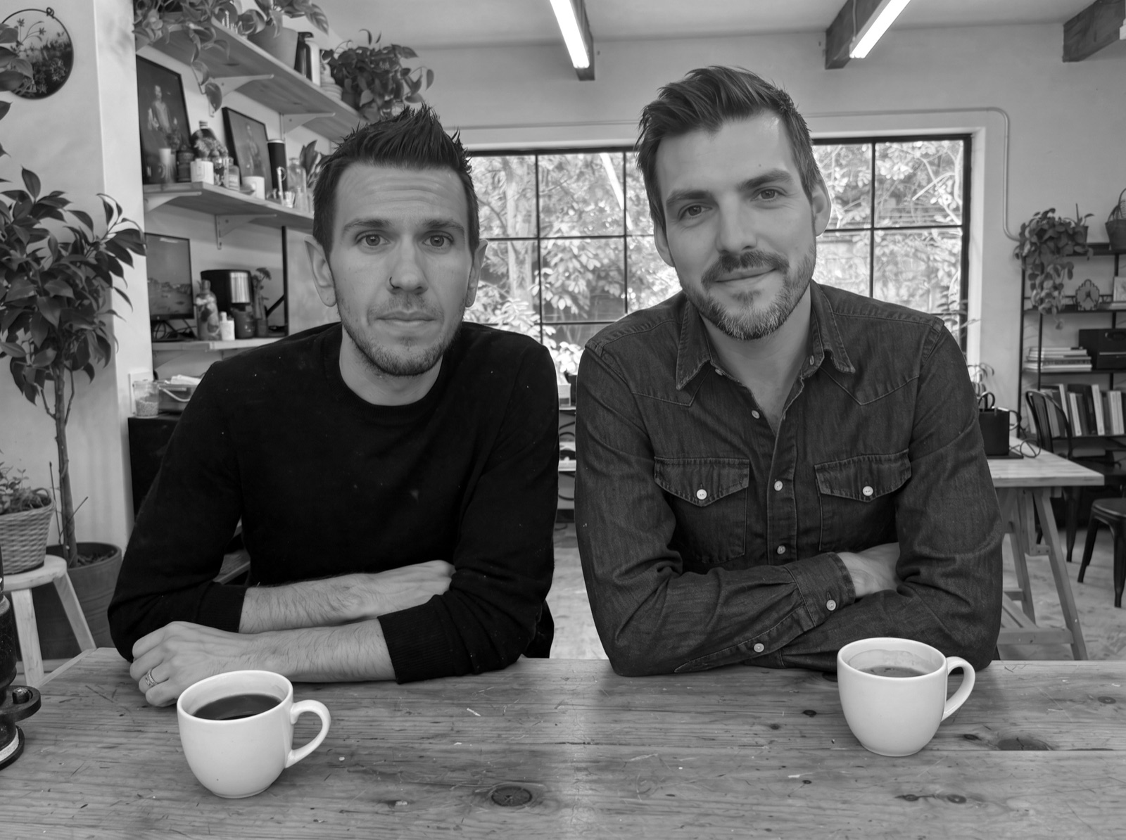 Steve and Nolan at the studio table with two coffees
